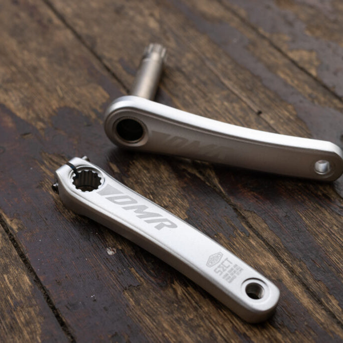 Bicycle cranks on a wooden surface