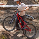 DMR Rider Kerenza Scott pushing a Bike