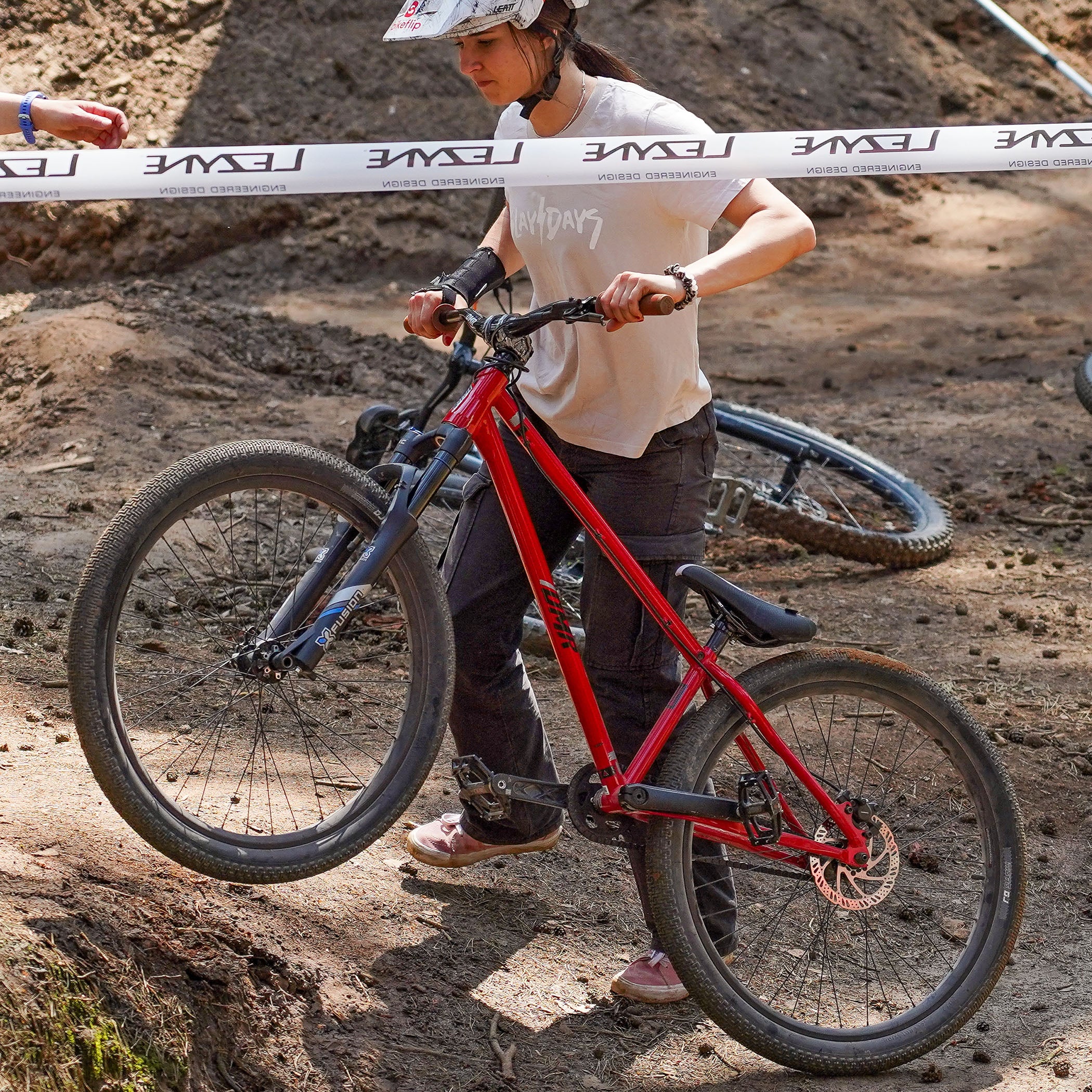 DMR Rider Kerenza Scott pushing a Bike