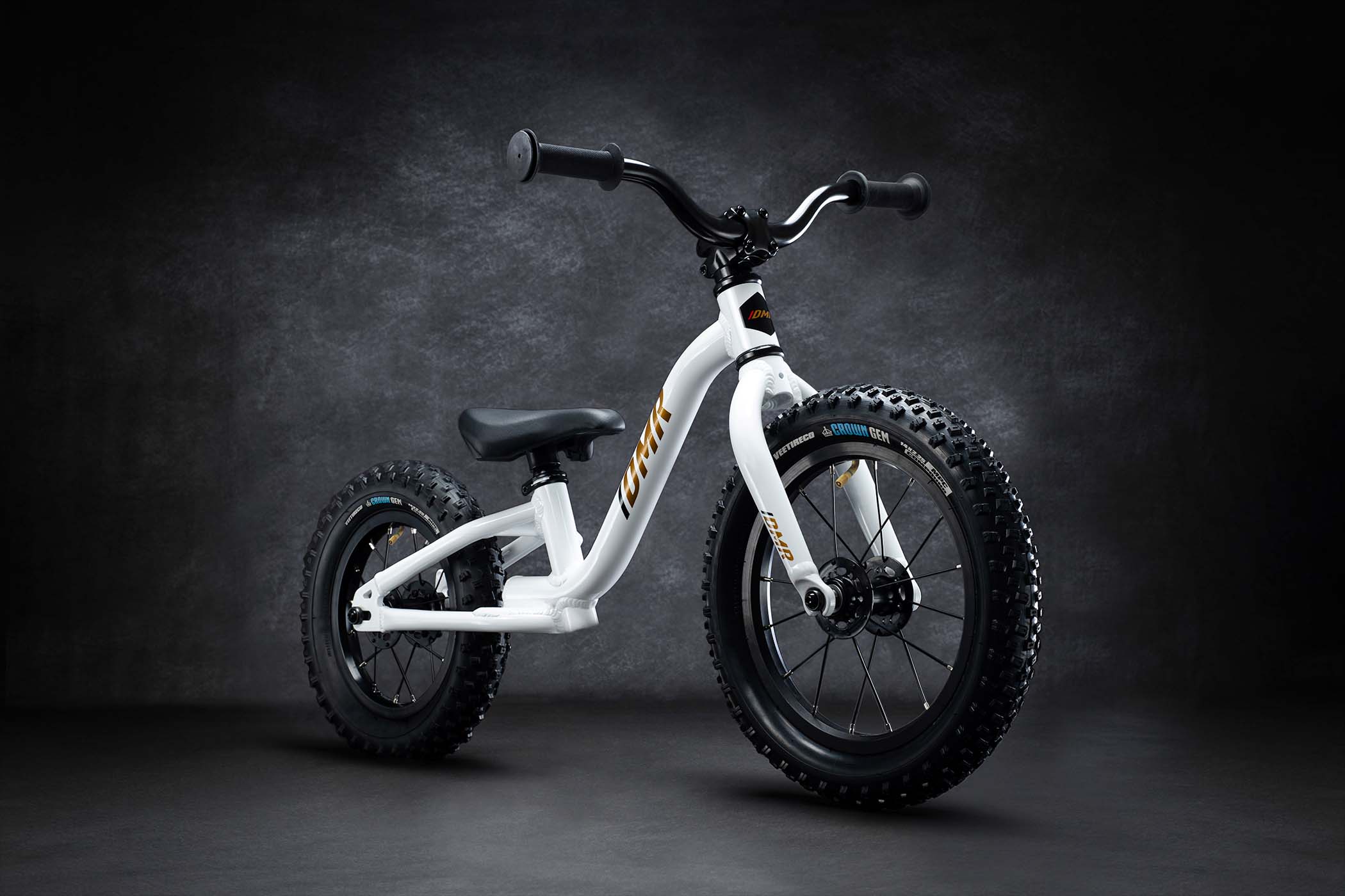 DMR Sidekick Balance Bike kids off-road mountain balancing balance bicycle bike for children on a grey background. This DMR Sidekick Balance Bike kids off-road mountain balancing balance bicycle bike for children is White in colour.