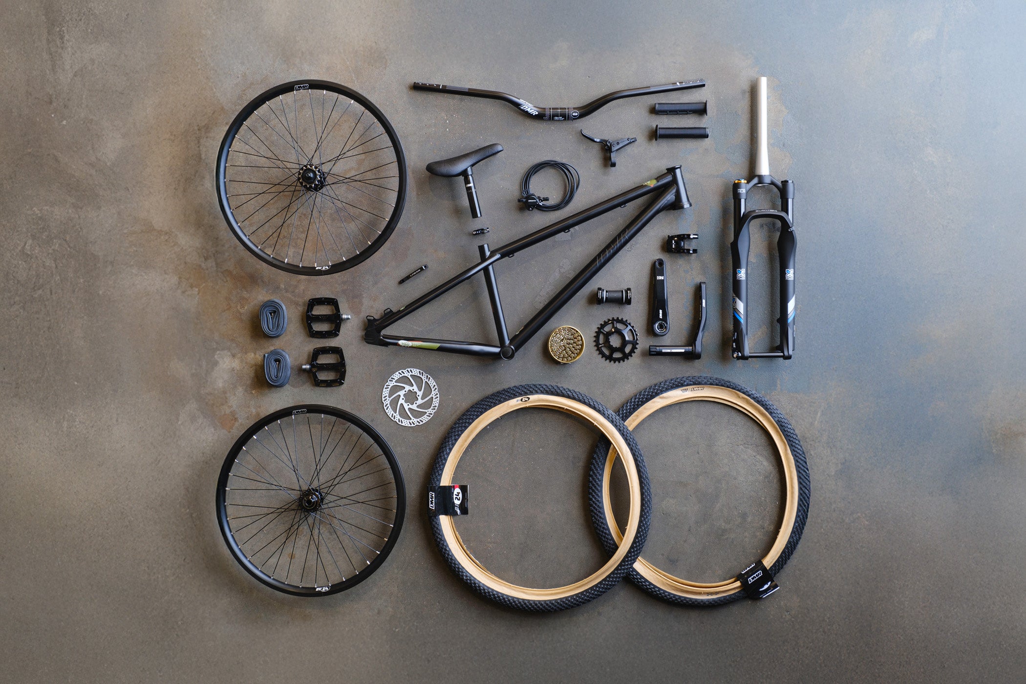 DMR Sect Custom 24" Dirt Jump off-road mountain cycling cycle bike bicycle frame in Matte Black, surrounded by off-road mountain cycling cycle bike bicycle components.