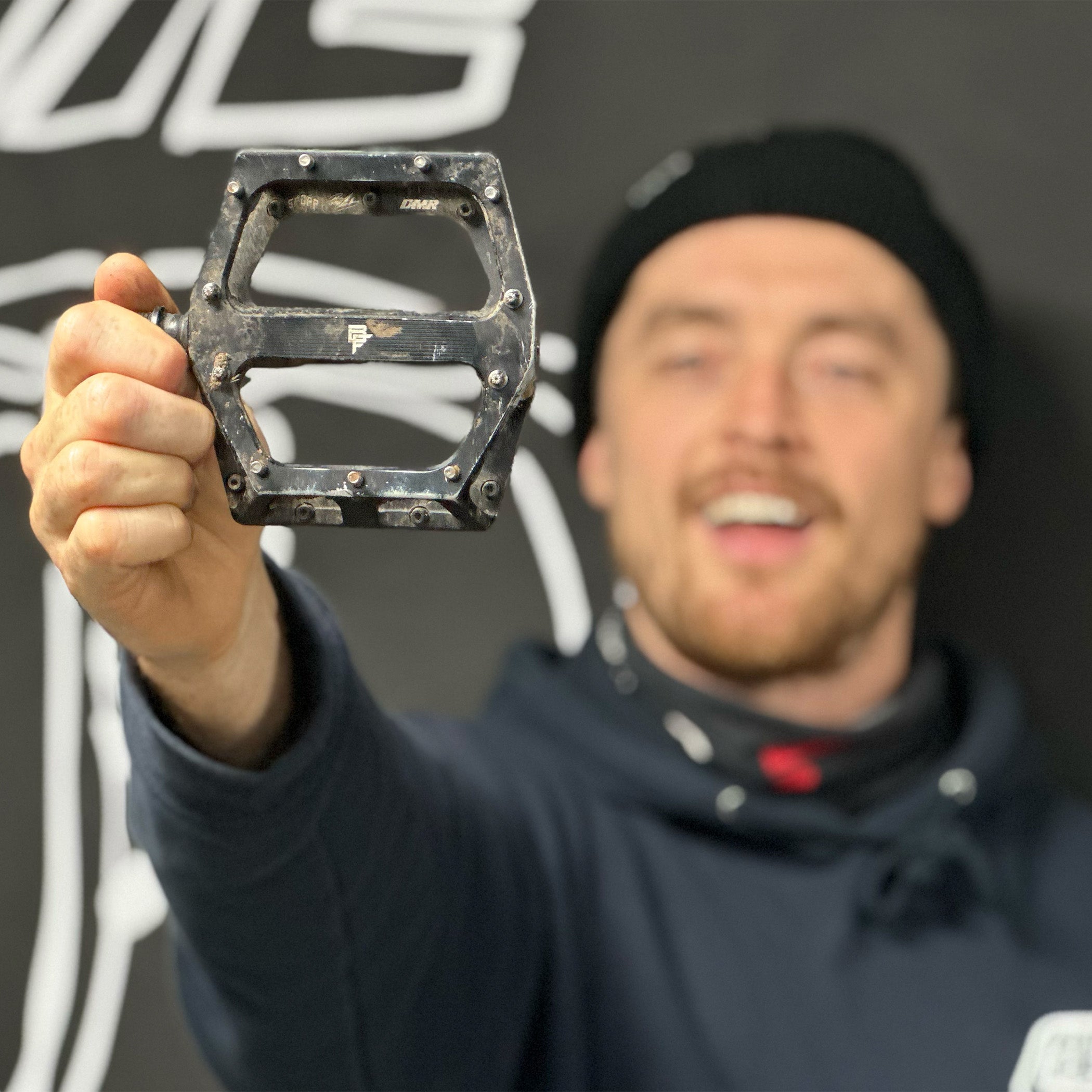 DMR Rider Olly Wilkins ODUB holding a pedal