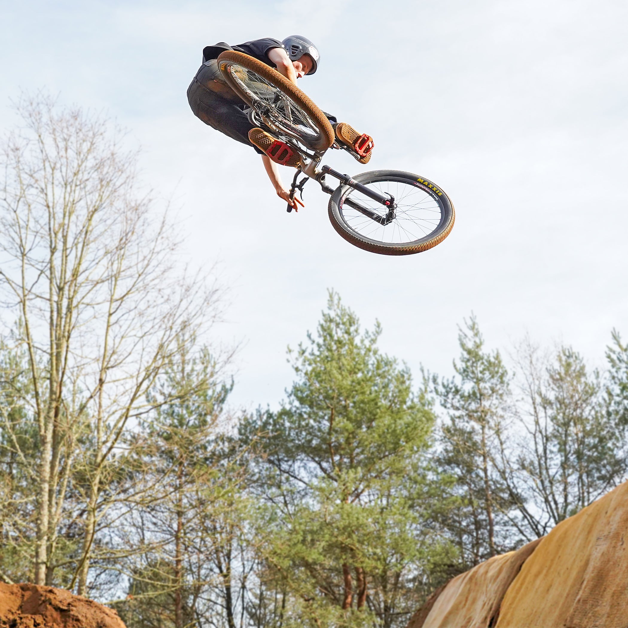 DMR Rider Sam Marzetti jumping a bike