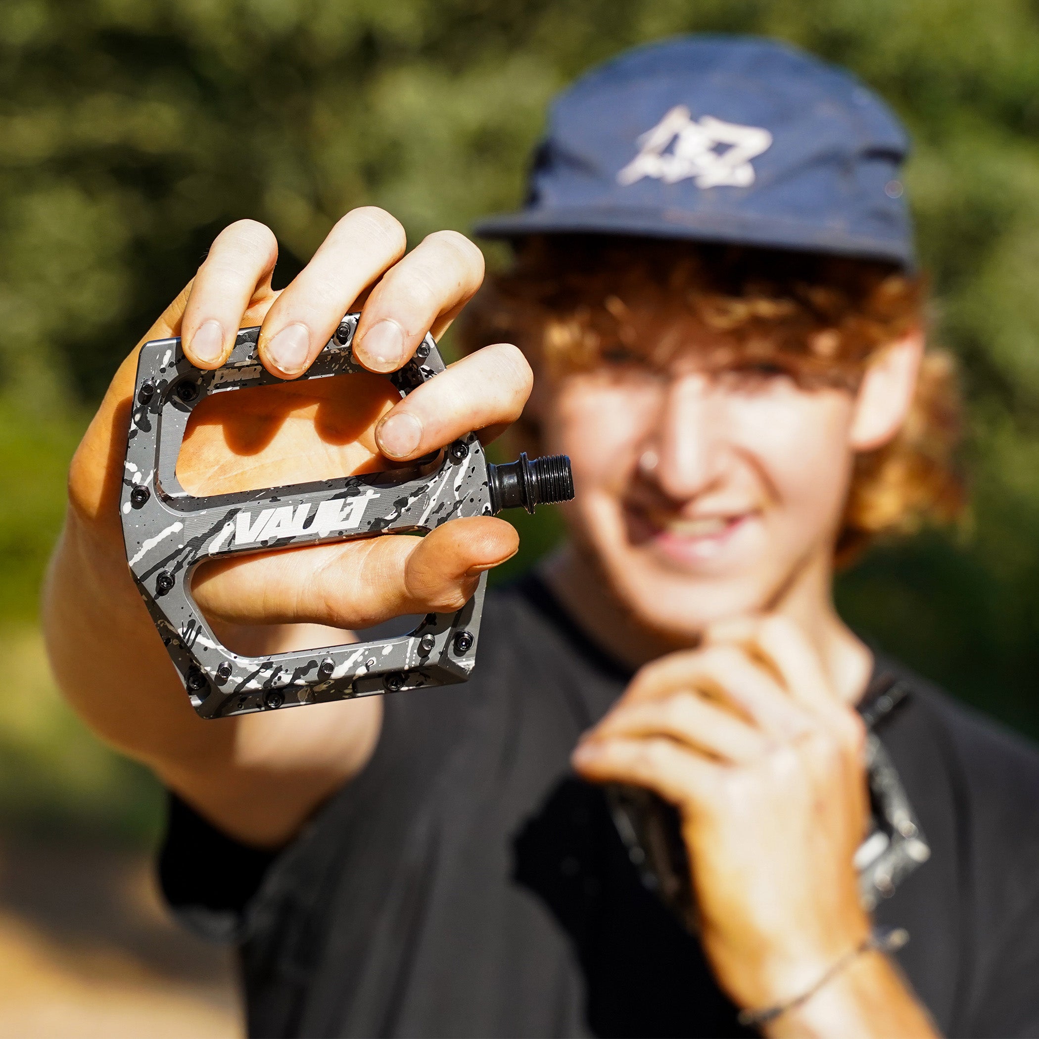 DMR Rider Andy Lehmann holding a pedal