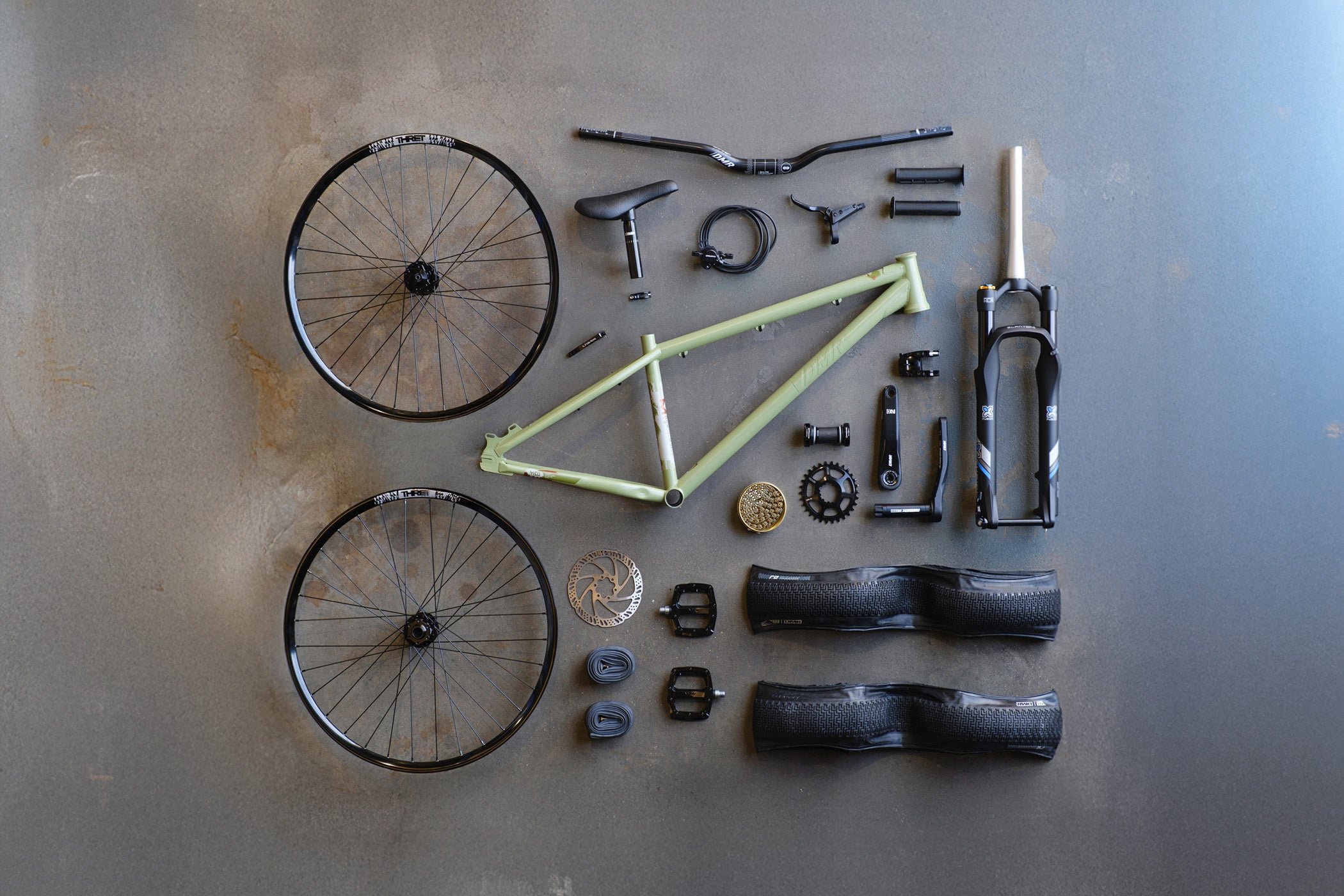 DMR Sect Custom 26" Dirt Jump off-road mountain cycling cycle bike bicycle frame in Pistachio Green, surrounded by off-road mountain cycling cycle bike bicycle components.