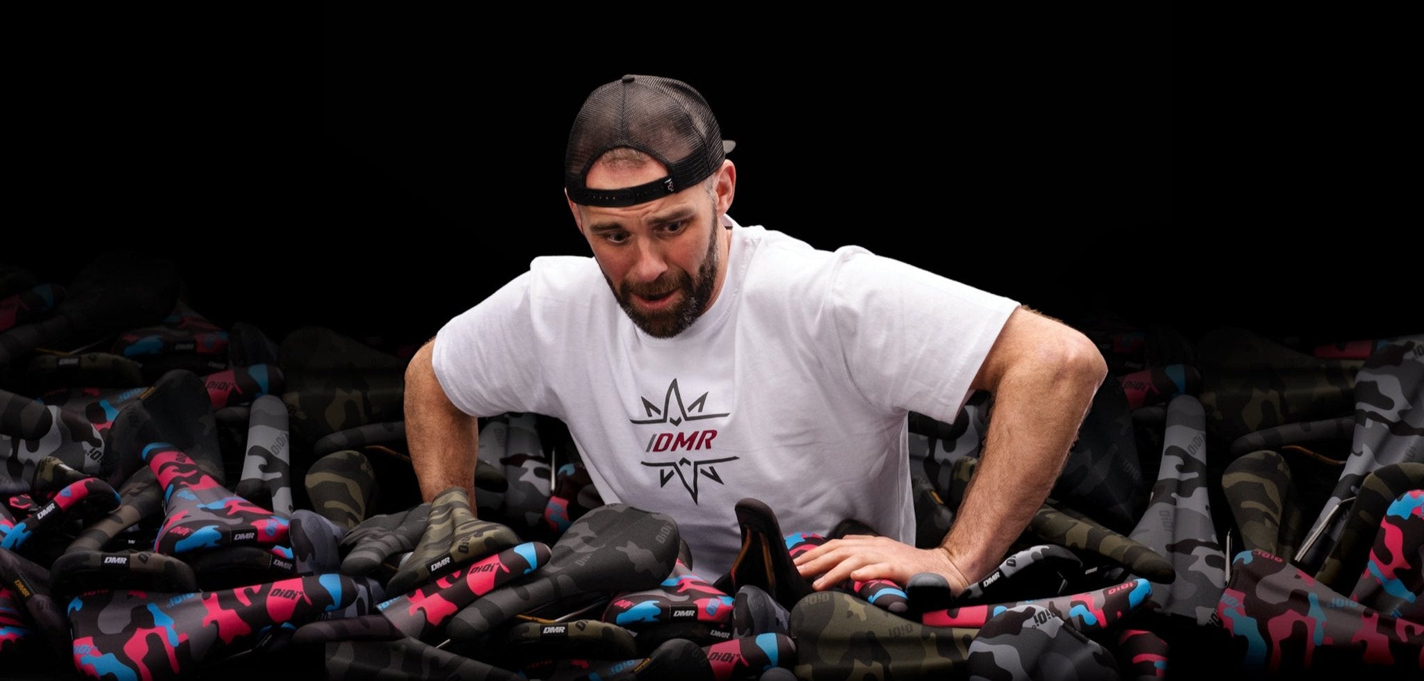 DMR Rider Ben Deakin in a pile of DMR OiOi Saddles
