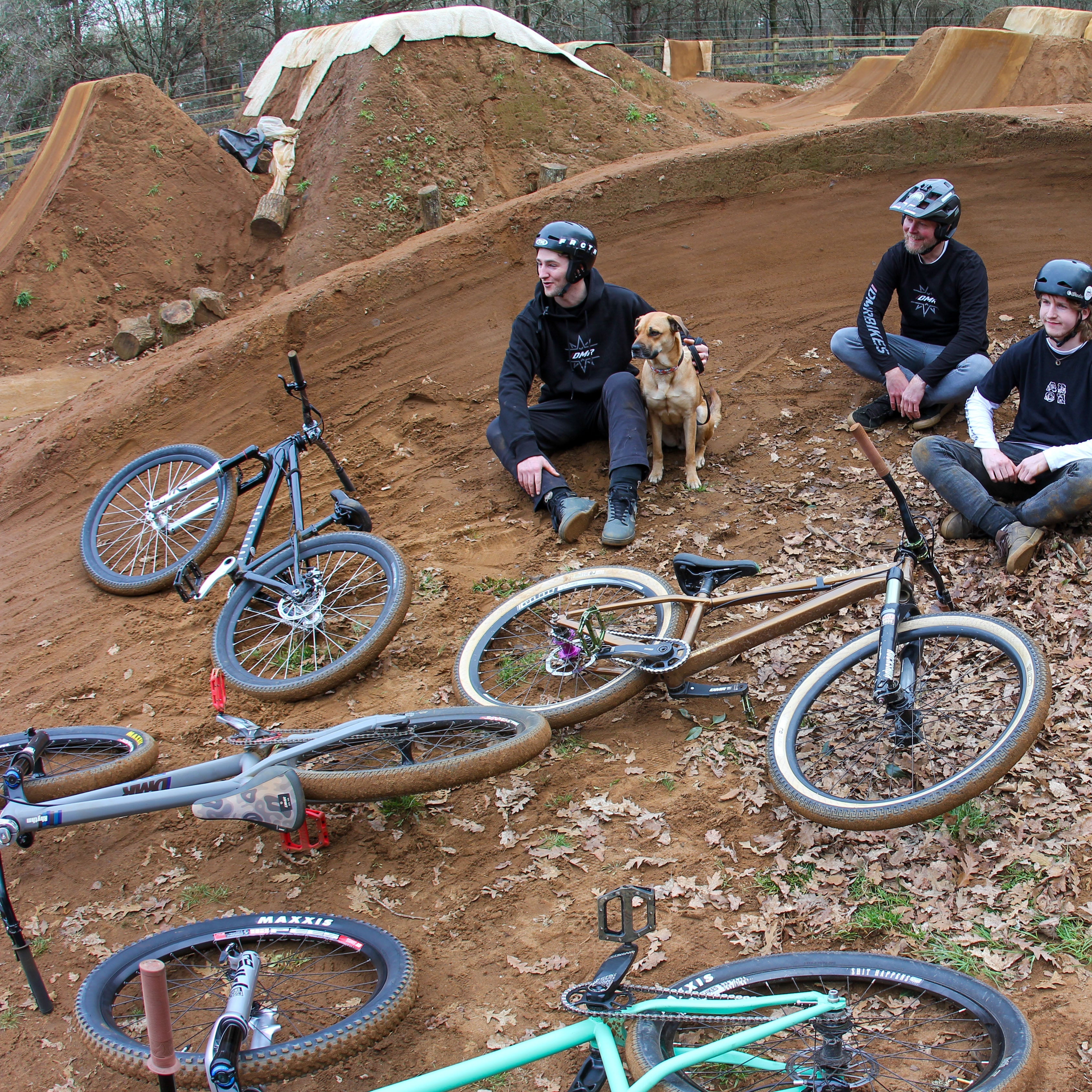 DMR Riders Sitting Amongst Dirt Jumps