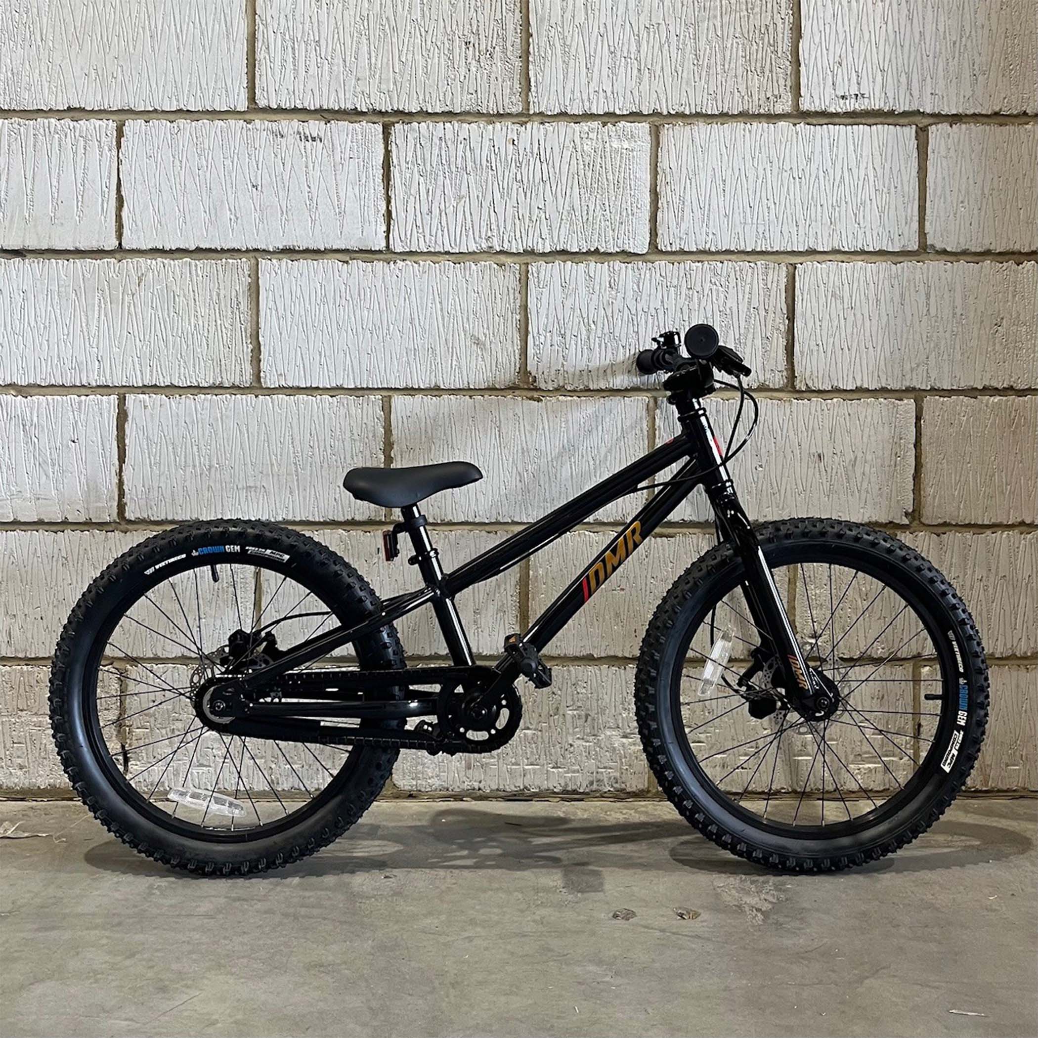 Ex Display DMR Sidekick Ride Bike against a warehouse wall
