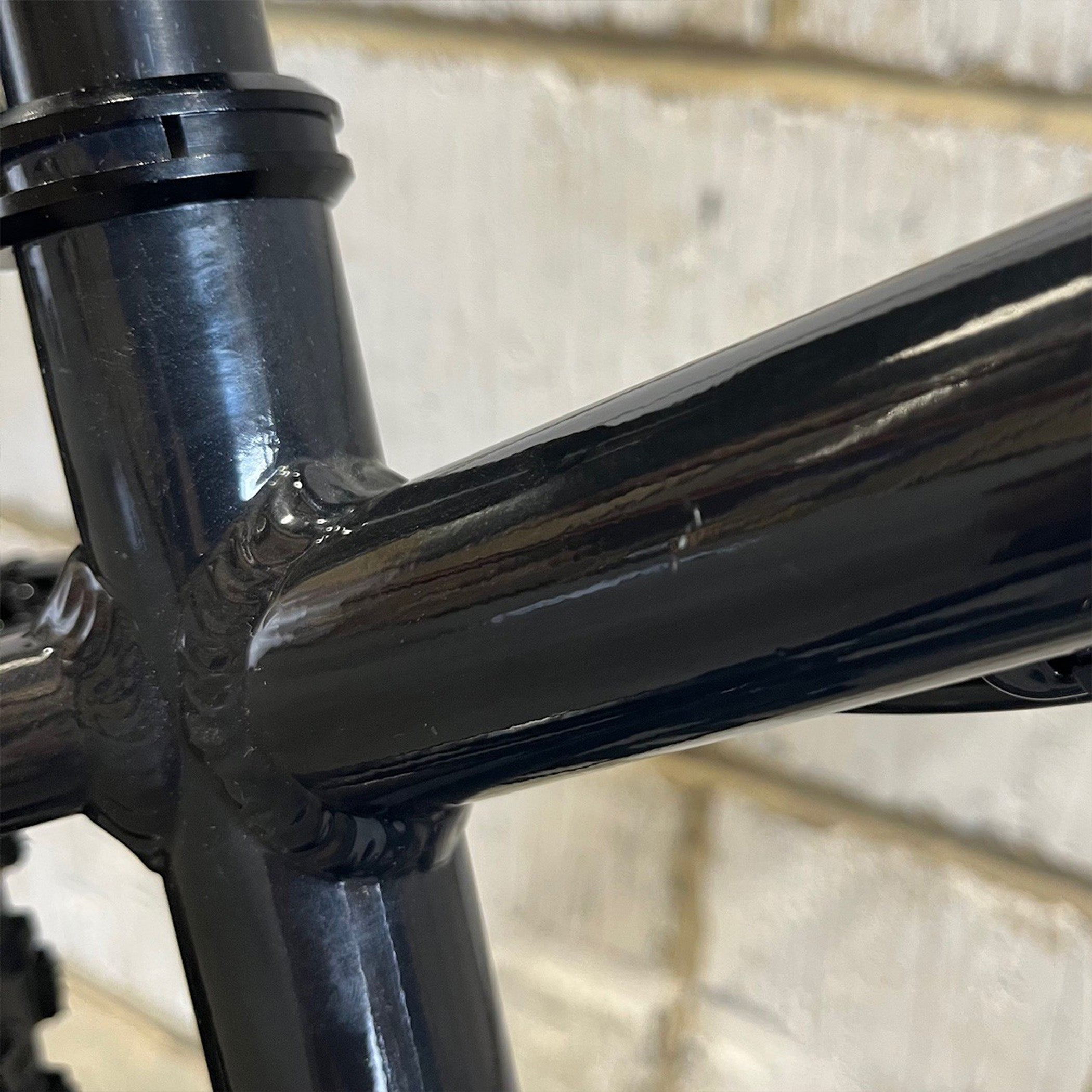Close-up of a Ex Display DMR Sidekick Ride Bike top tube scratch