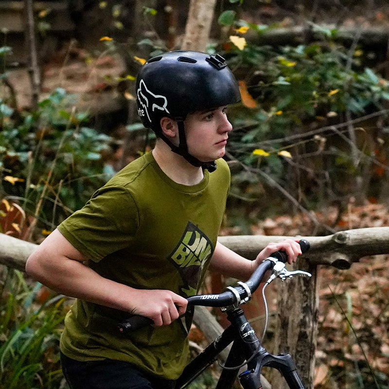 A person who goes by the alias Ed Knight, pushing his DMR Sect off-road mountain cycling cycle bicycle bike, whilst in a woodland surrounding.