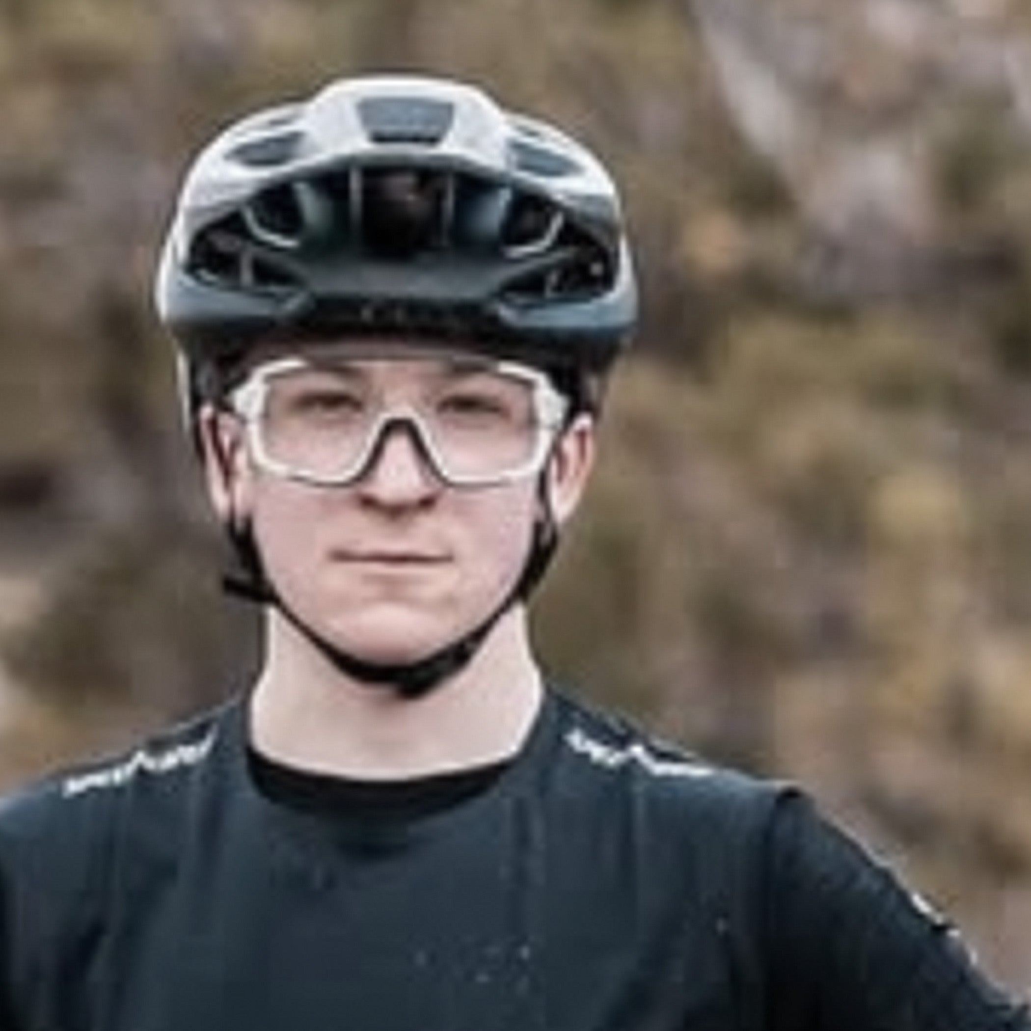really blurry and pixelated photo of a person wearing a helmet and goggles with a blurred natural background