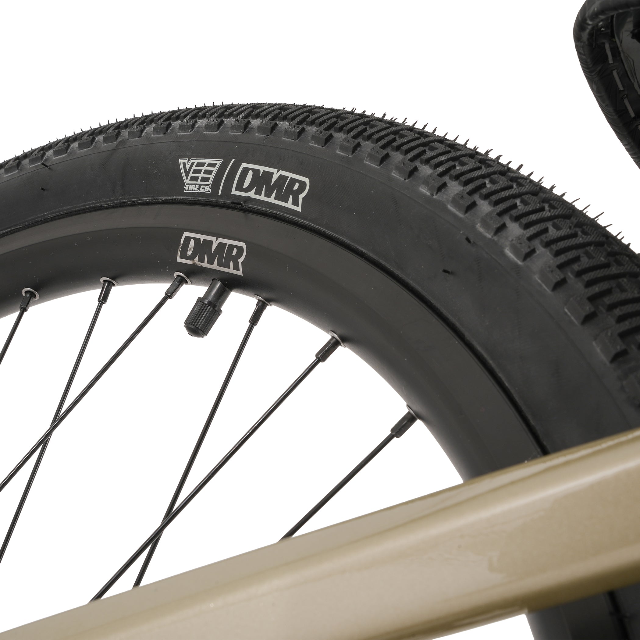 Close-up of a bicycle wheel with DMR branding on a white background