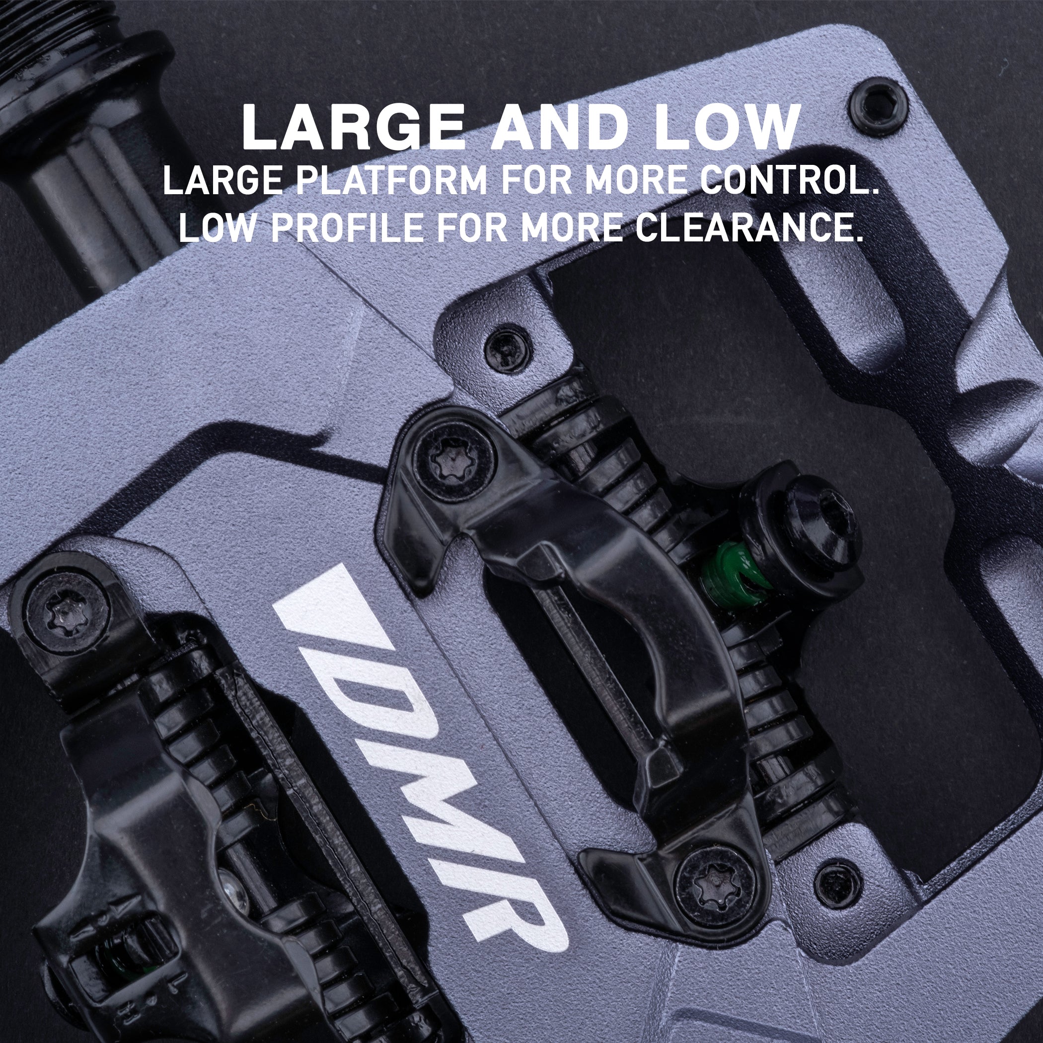 Close-up photograph of the DMR VMAX clipless clip clipped spd cleat mtb off-road mountain cycling cycle bike biking pedal pedalling product, coloured in Grey, showing cleat mechanism. This mtb off-road mountain cycling cycle bike biking pedal pedalling product has been placed on a dark grey background.
