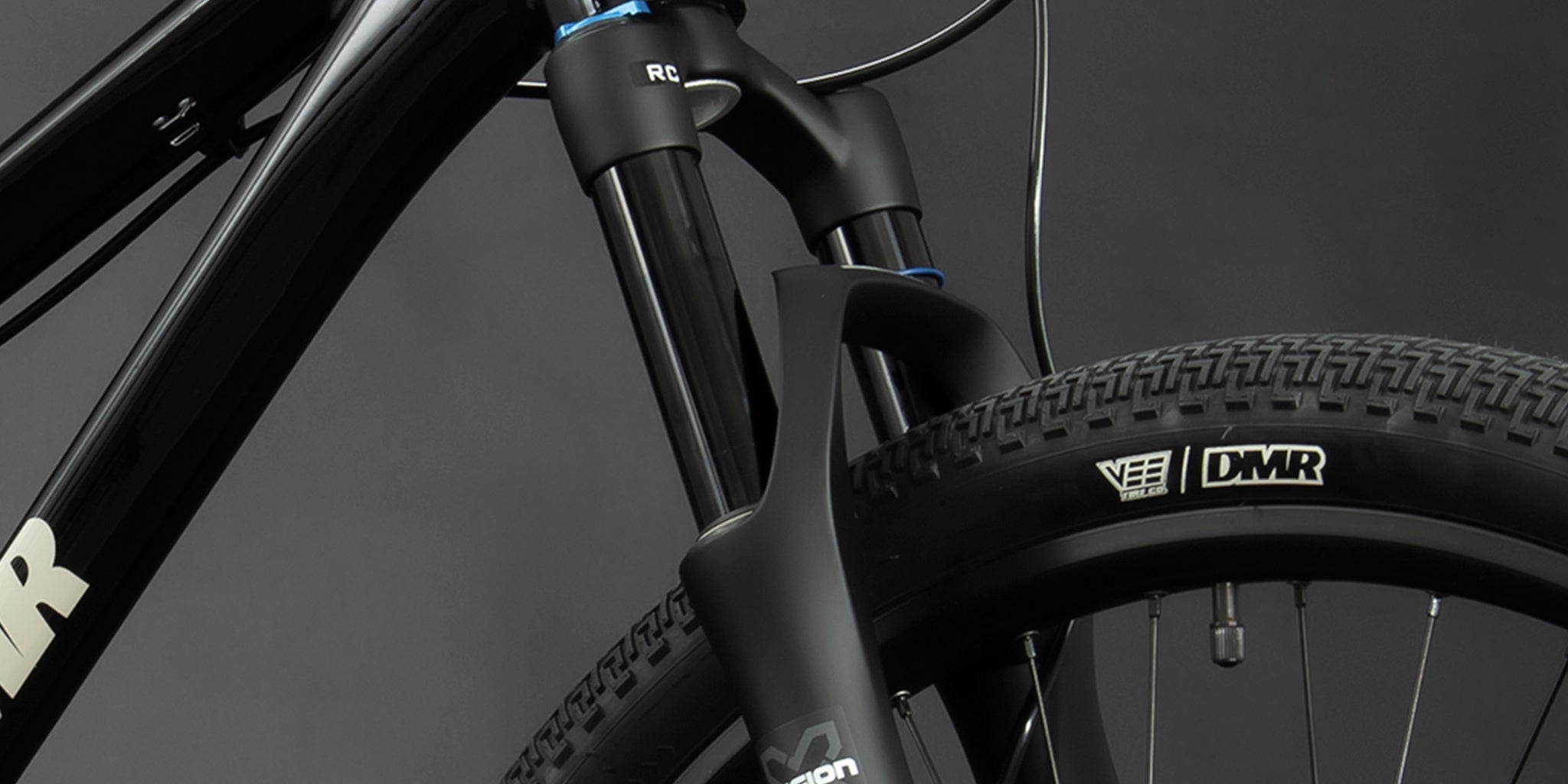 close-up of a dmr bikes rhythm pro dirt jumper bike frame in black, on a dark grey background