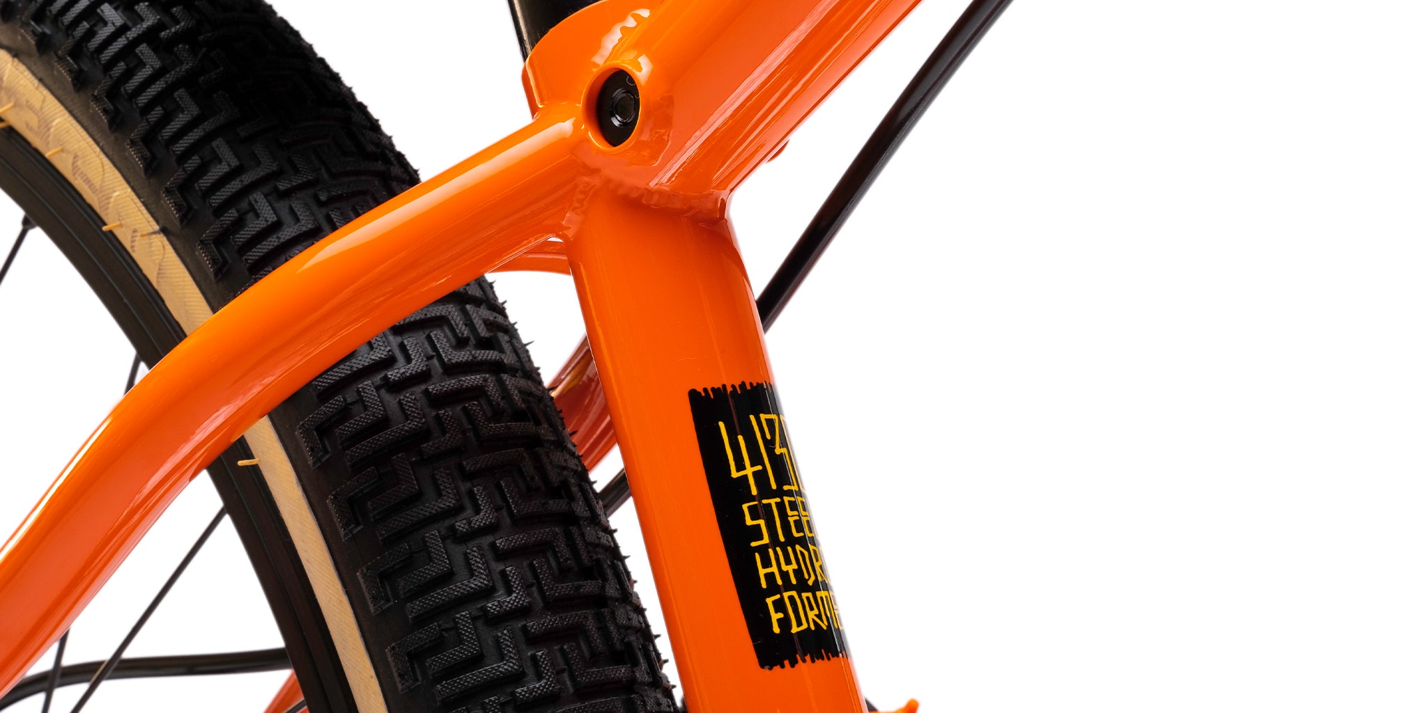 close-up of a dmr bikes sect dirt jumper bike frame in orange, on a white background