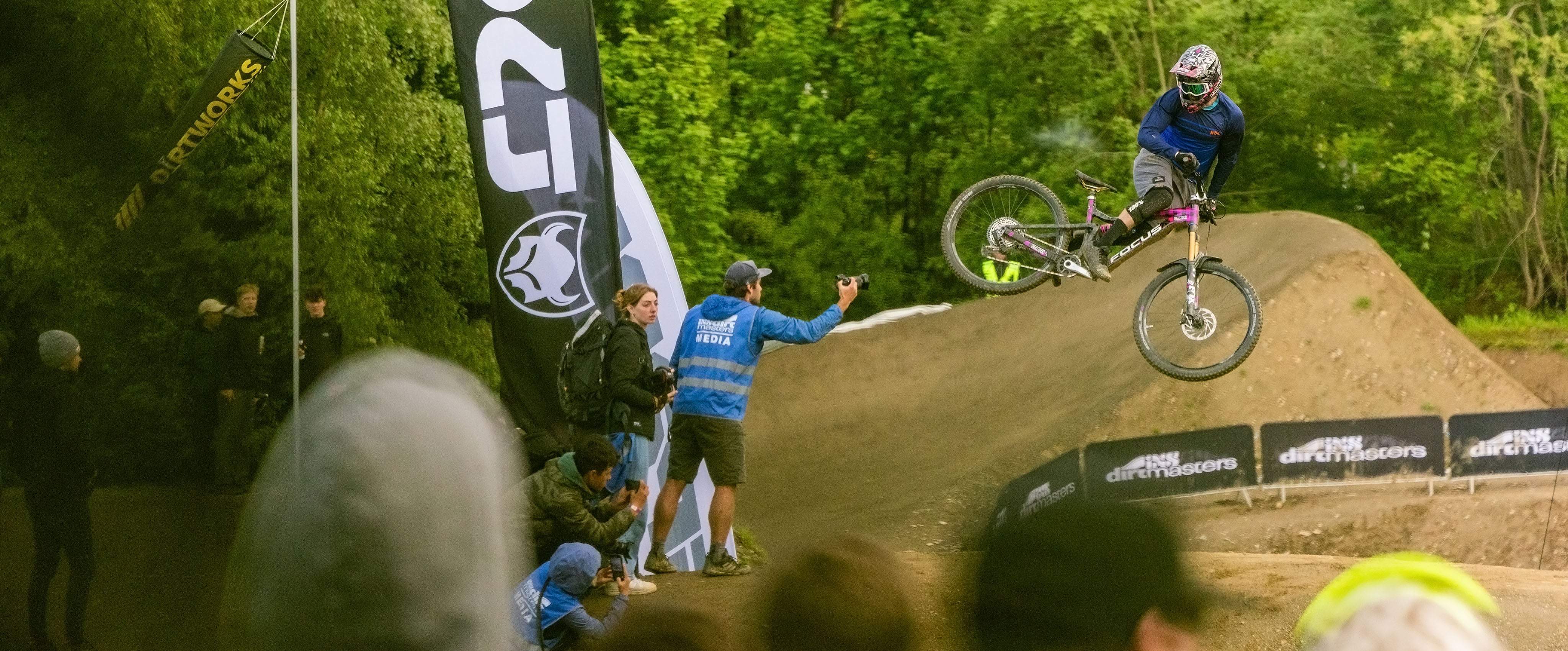 man on bike ride away from man with camera but in air look wrong way bike go broom neow