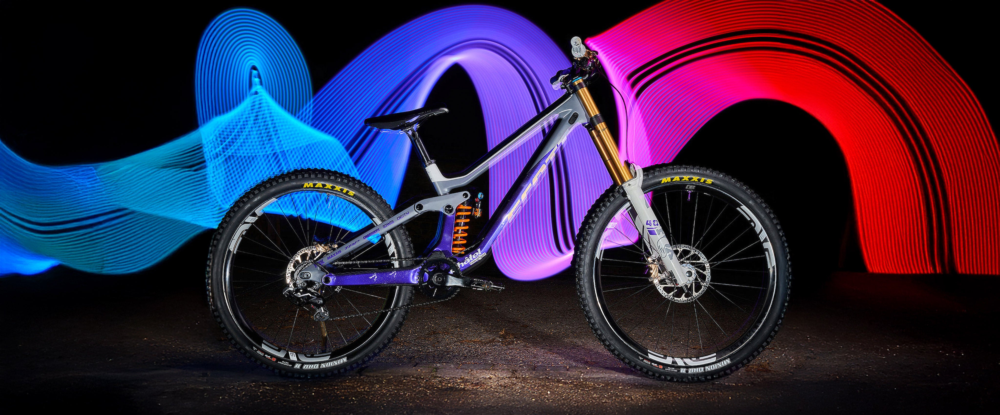 Mountain bike in front of colorful, abstract light sculptures