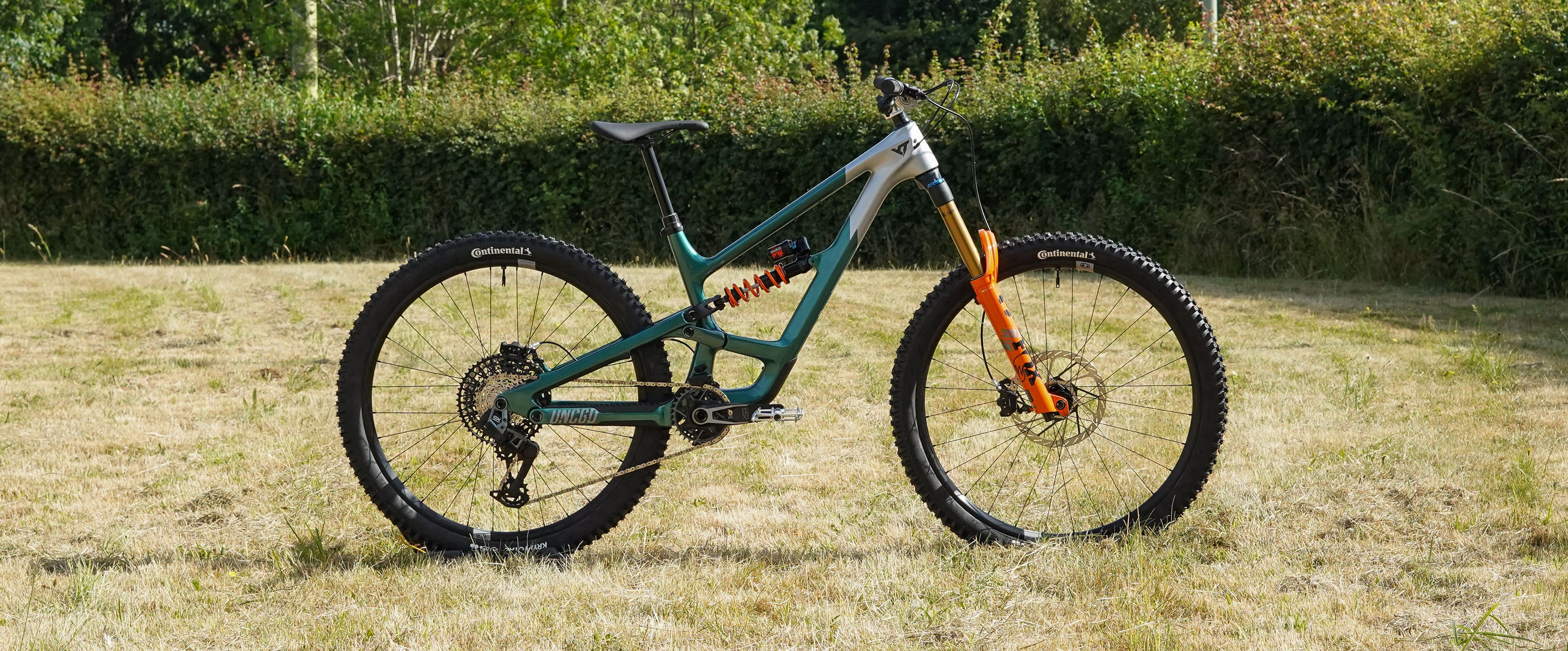 Mountain bike on a grassy field with trees in the background
