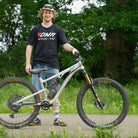 Team rider Andy Lehmann wearing a black t-shirt with DMR Bicycles & Dirt logo standing with his bike
