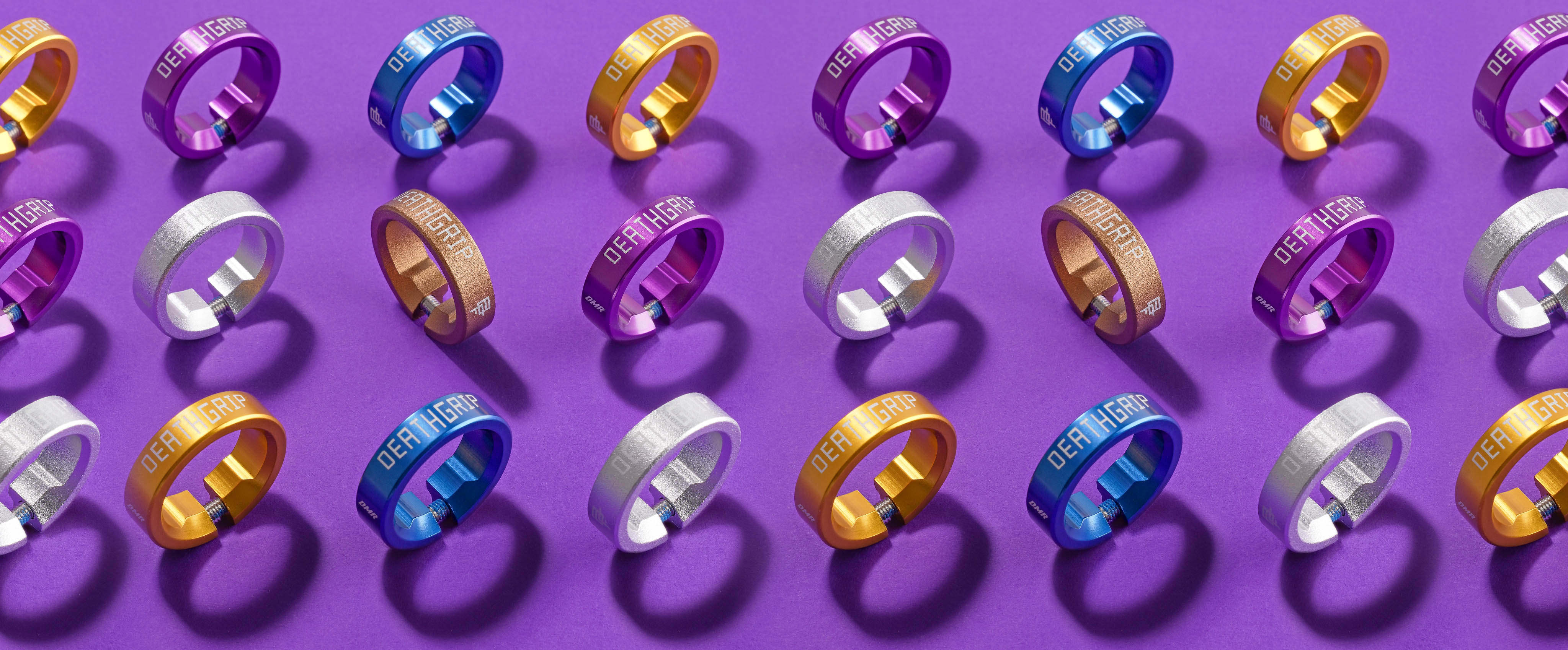 Colorful grip collars arranged in a grid on a purple background