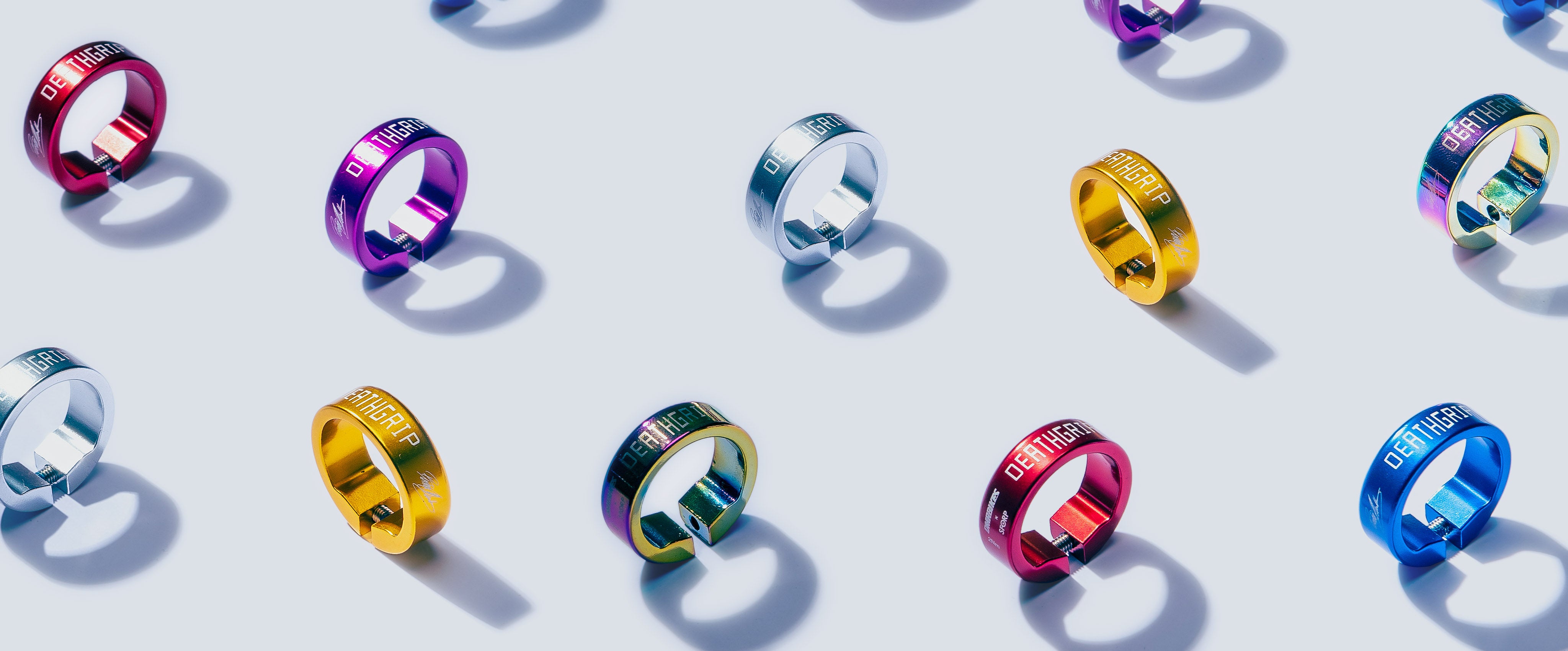 Colourful grip collars with visible brand name on a light grey background