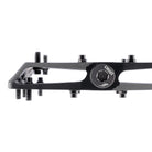 A black MTB pedal with mounting bolts and a circular silver logo plate reading 'DMR'.