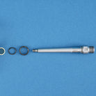 silver pedal axle with bushing and seals arranged on a blue background