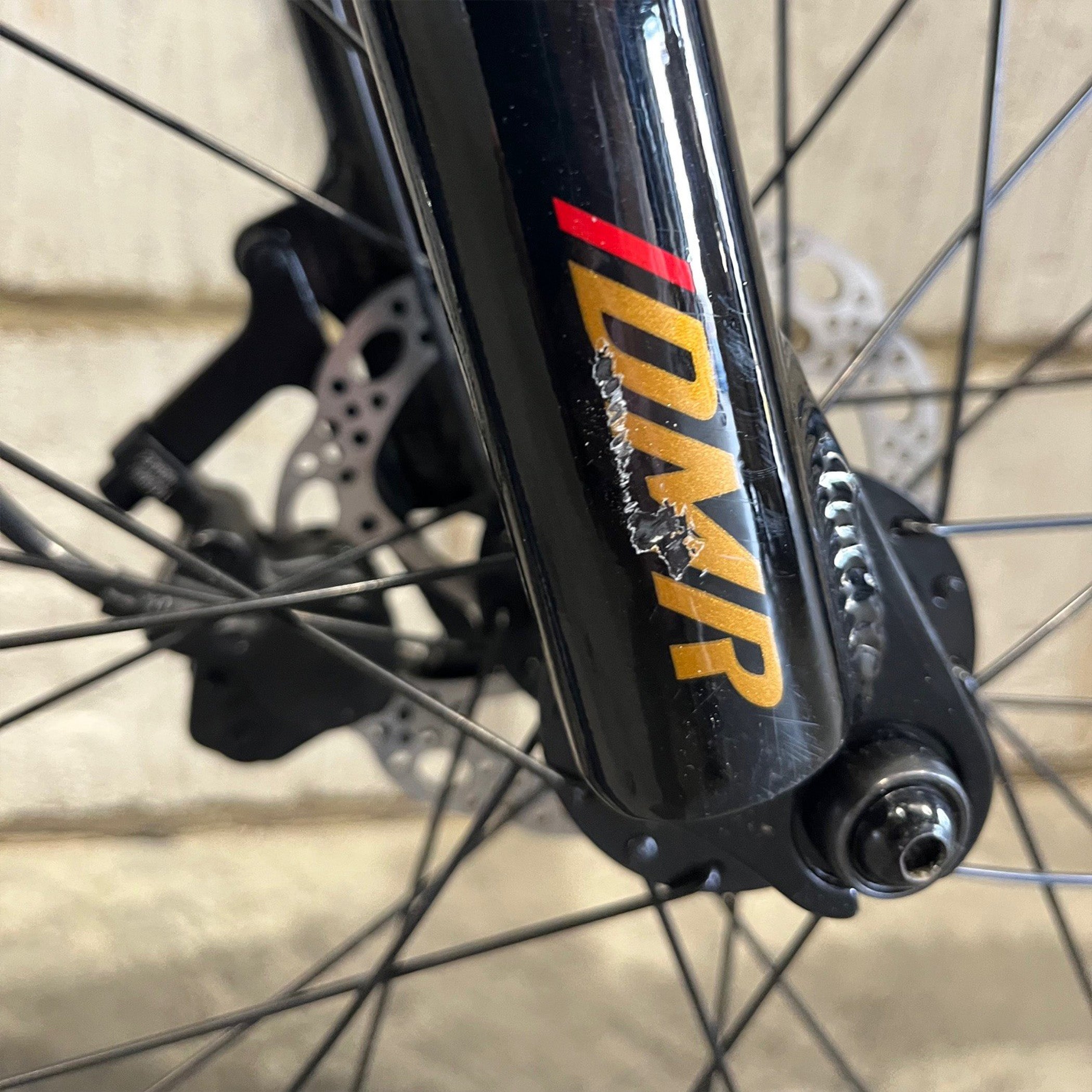 Close-up of a Ex Display DMR Sidekick Ride Bike fork with 'scratches
