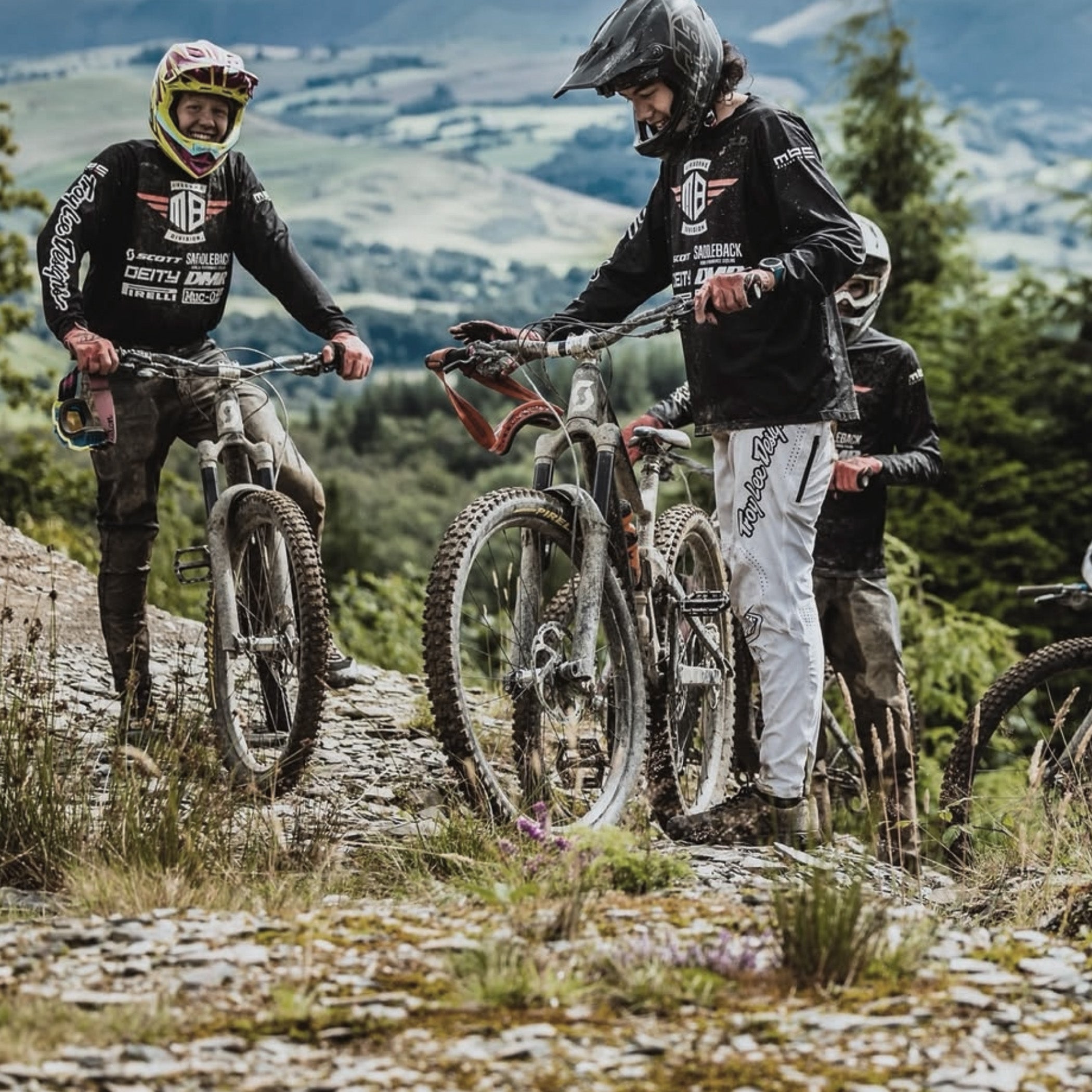 Two mountain bikers on a trail with scenic background
