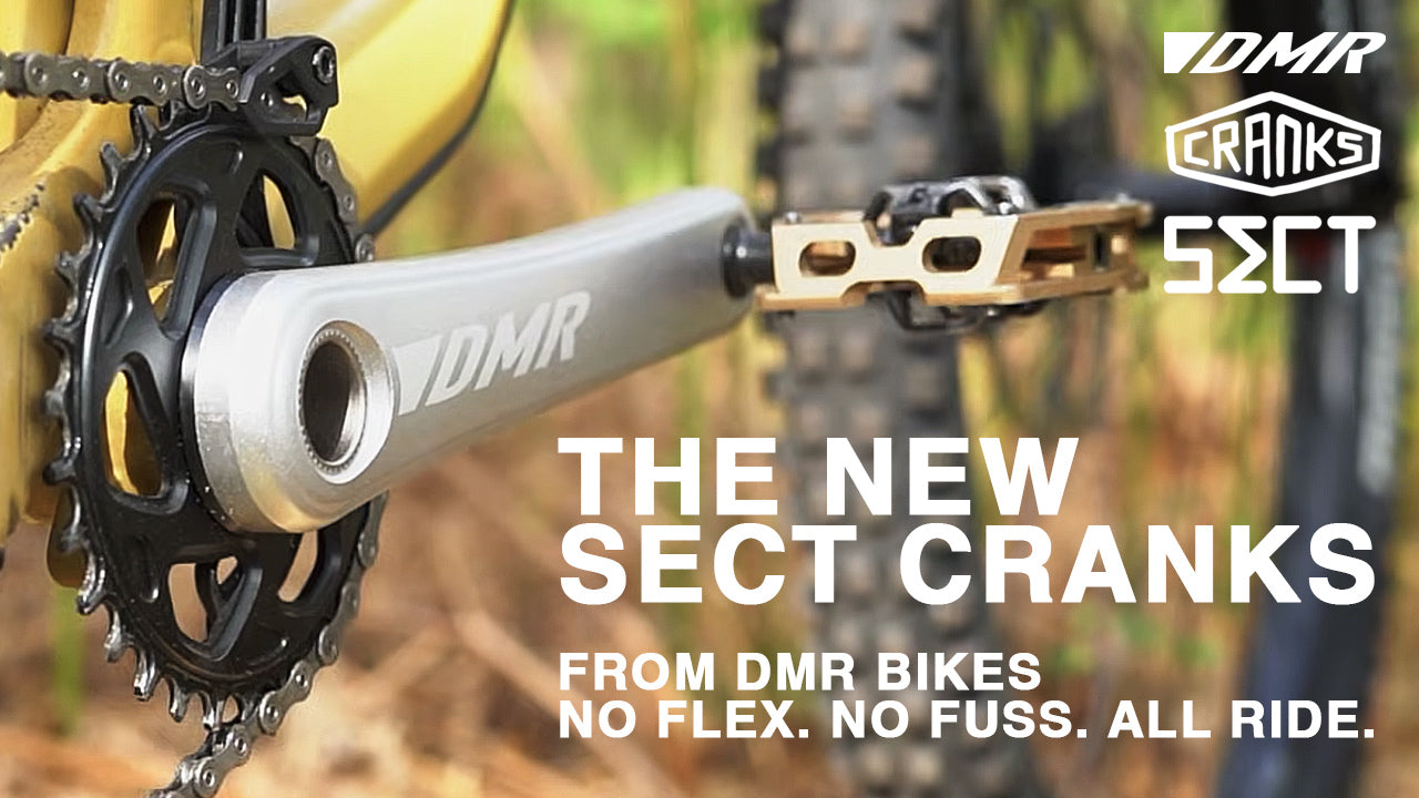 Close-up of DMR Sect cranks on a bike with text highlighting the product.