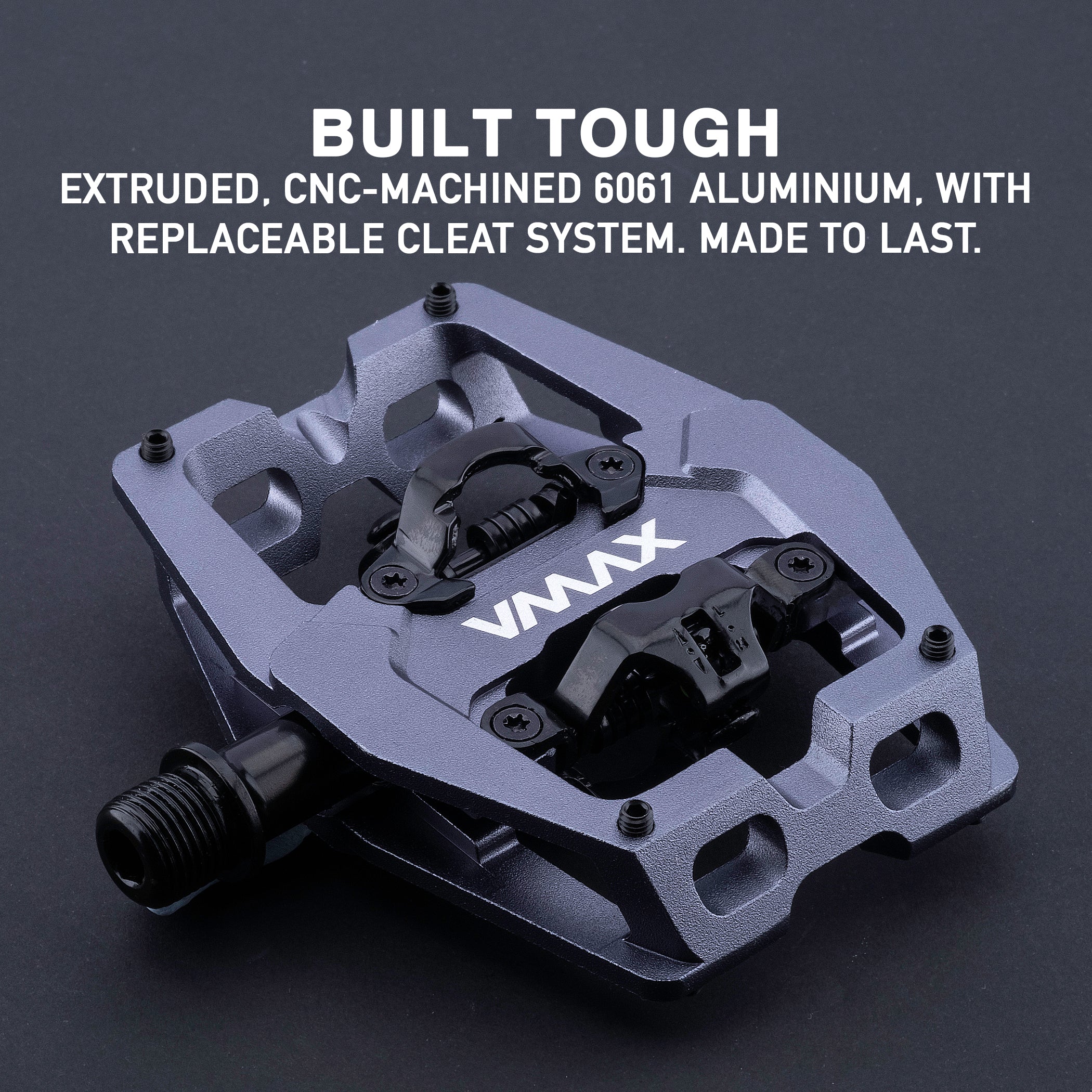 Close-up photograph of the DMR VMAX clipless clip clipped spd cleat mtb off-road mountain cycling cycle bike biking pedal pedalling product, coloured in Grey. This mtb off-road mountain cycling cycle bike biking pedal pedalling product has been placed on a dark grey background.