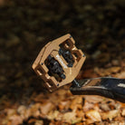Close-up of the Light Bronze DMR VMAX clipless clip-in clip clipped SPD off-road mountain cycling bicycle bike pedalling pedal product, with an autumnal background composing of leaves other foliage.