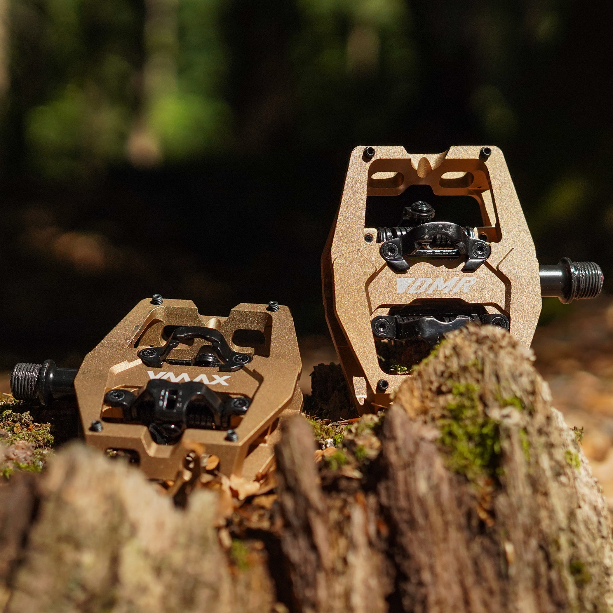 Close-up of the Light Bronze DMR VMAX clipless clip-in clip clipped SPD off-road mountain cycling bicycle bike pedalling pedal product, with an autumnal background composing of leaves other foliage.