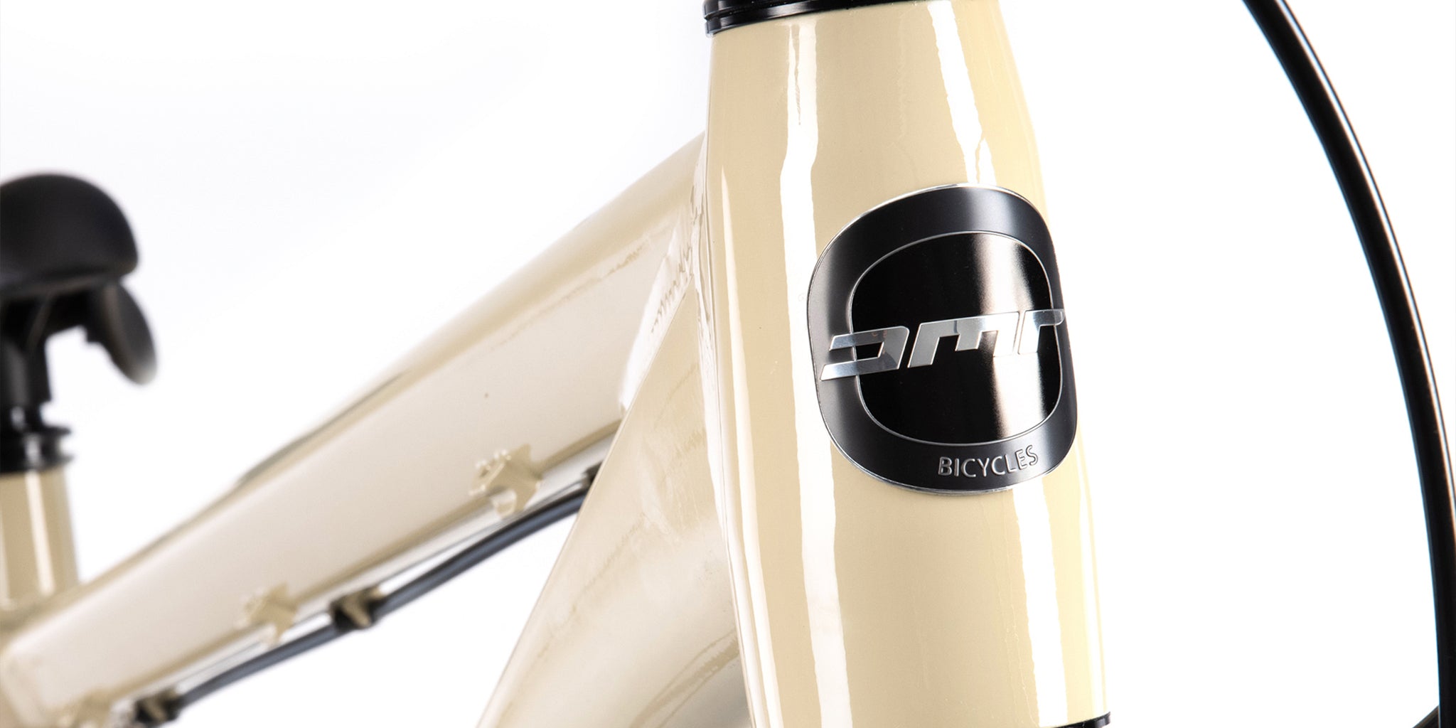 close-up of a dmr bikes rhythm team dirt jumper bike frame in sand brown, on a white background