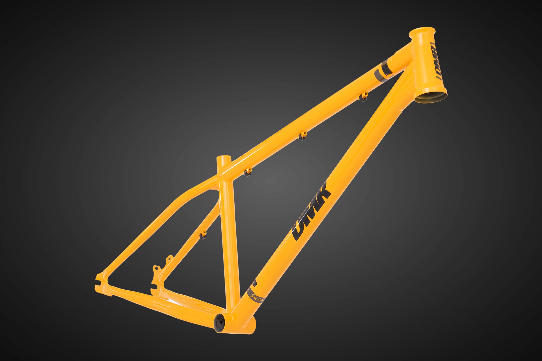 dmr bikes sect custom dirt jumper frame in dakar yellow on a grey background